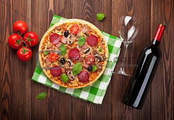 Italian pizza with pepperoni and red wine