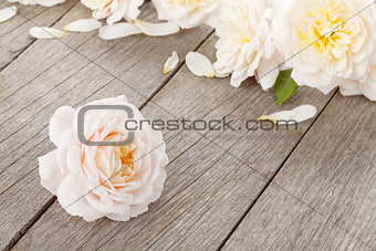 Fresh rose flowers on wooden background
