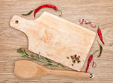 Cutting board with spices around over wooden table