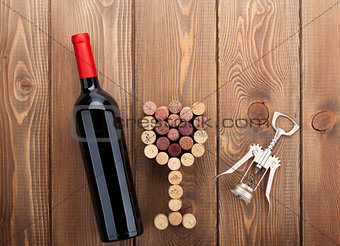 Red wine bottle, glass shaped corks and corkscrew