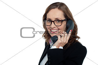 Bespectacled woman talking over the phone