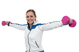 Woman holding dumbbells in her outstretched arms