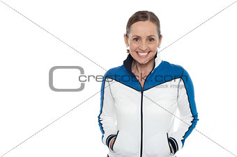 Woman in sporty jacket smiling warmly