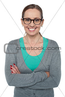 Brunette with folded arms posing cheerfully