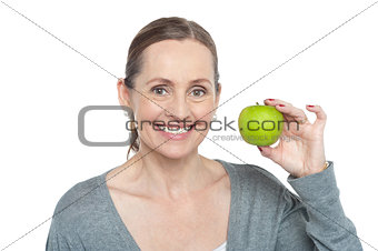 Health conscious woman holding fresh green apple