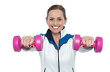 Female working out with pink dumbbells