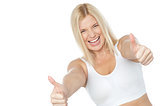 Tilted image of cheerful lady showing thumbs up