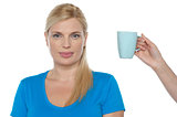 Woman is being offered a cup of beverage
