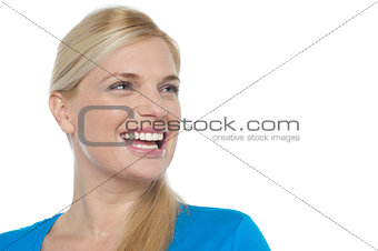 Snap shot of a woman laughing while looking away