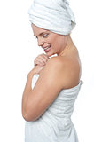 Female wrapping herself in towel after hot spa