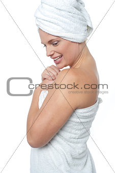 Female wrapping herself in towel after hot spa