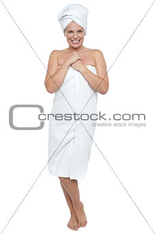 Full length portrait of a woman wrapped in towel