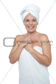 Blonde woman in towel smiling heartily