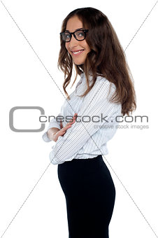 Young corporate woman wearing eyeglasses standing sideways