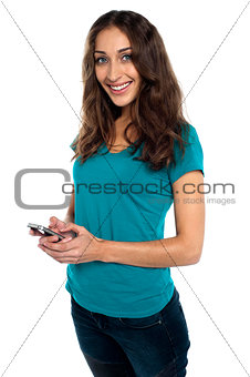 Joyous woman messaging her boyfriend