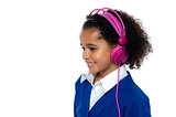 Charming young kid listening to music