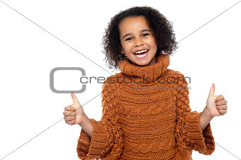 Pretty kid laughing and showing double thumbs up