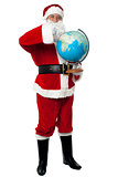 Santa pointing out a continent on globe