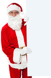 Aged Santa holding blank white banner ad board