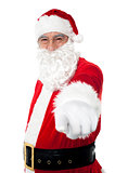 Elderly cheerful Santa pointing at you