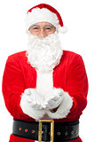 Bespectacled Father Santa posing with open palms