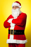 Confident male Santa posing with arms folded
