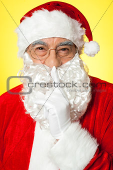 Shh...Aged Santa gesturing silence