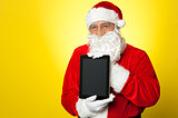 Santa Claus holding newly launched tablet device