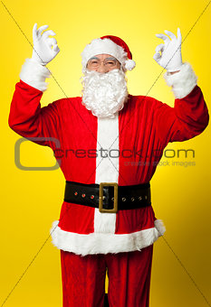 Aged Santa gesturing perfect sign with both hands