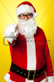 Jelly-belly Santa in spectacles pointing at you