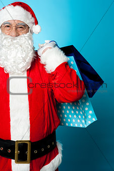 Saint Nicholas carrying colorful shopping bags