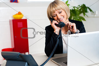 Secretary attending call before passing it to boss