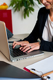 Cropped image of female manager working on laptop