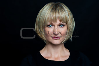 Blonde woman isolated against black background