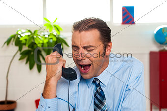 Businessman yelling during the phone call