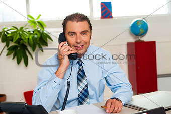 Smiling businessman attending work call