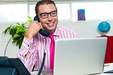 Happy executive engaged on a business call