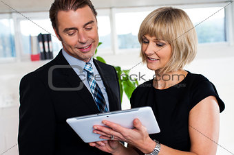 Secretary with tablet pc discussing bosses schedule