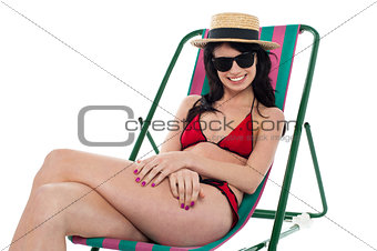 Sexy bikini model relaxing on deckchair