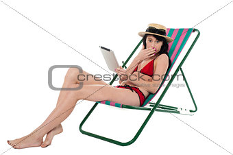 Amazed bikini lady holding tablet