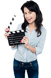 Joyous woman with clapperboard
