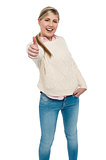 Happy teen girl showing thumbs up sign