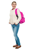 College student in winter wear posing with pink backpack