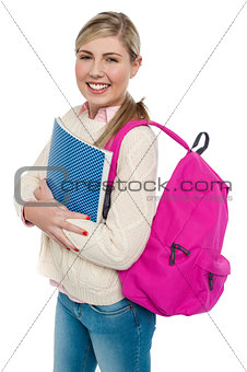 Joyful college student posing with pink backpack