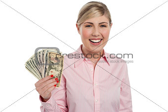 Pretty woman holding fan made of money