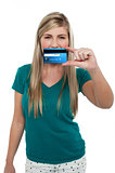 Casual teenager holding up credit card