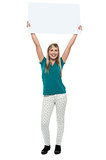 Woman holding ad board above her head