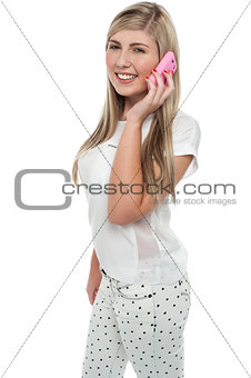 Young girl talking to her freind through cellphone