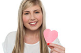 Pretty girl holding cute pink paper heart