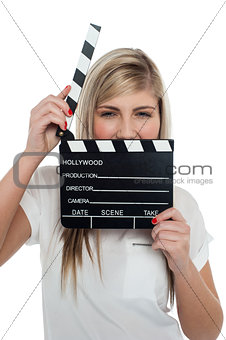Beautiful female with clapperboard. It's showtime.
